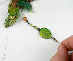 Beads being threaded onto wire